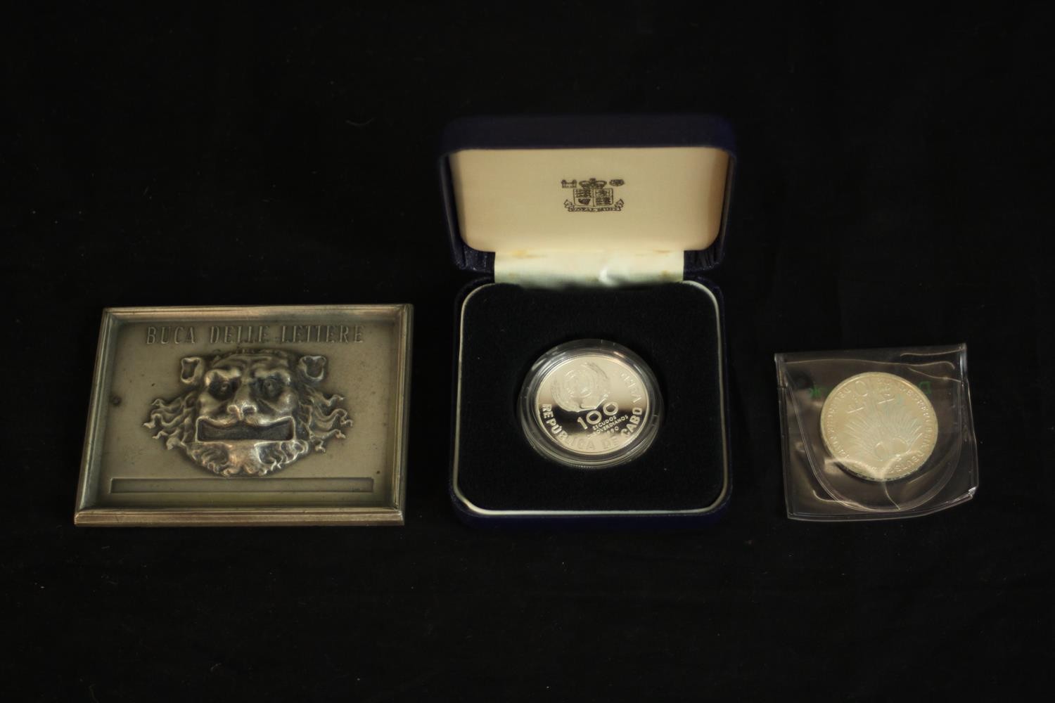 A cased 100 Escudos Papal visit silver proof coin along with a silver German coin and silver medal
