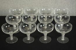 A set of twelve clear glass air twist stem champagne coupes. H.20 Dia.10cm. (largest)