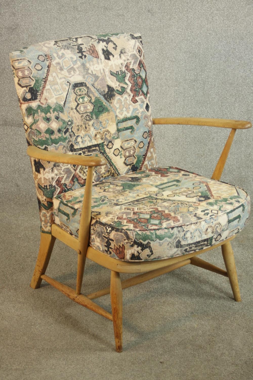 An Ercol beech armchair, with open arms, upholstered to the back and seat cushion. H.80 W.65 D.68cm. - Image 3 of 9