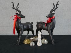 A pair of bronze effect stags along with a ceramic angel and two candlesticks. H.48 W.33 D.12cm