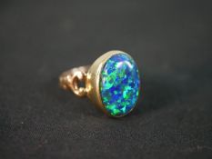 A red leather boxed synthetic opal and 9 carat gold dress ring. The ring box with a silver