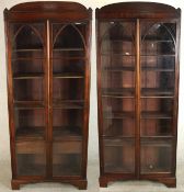 A pair of George III Gothic Revival mahogany bookcases, the two glazed doors with lancet details