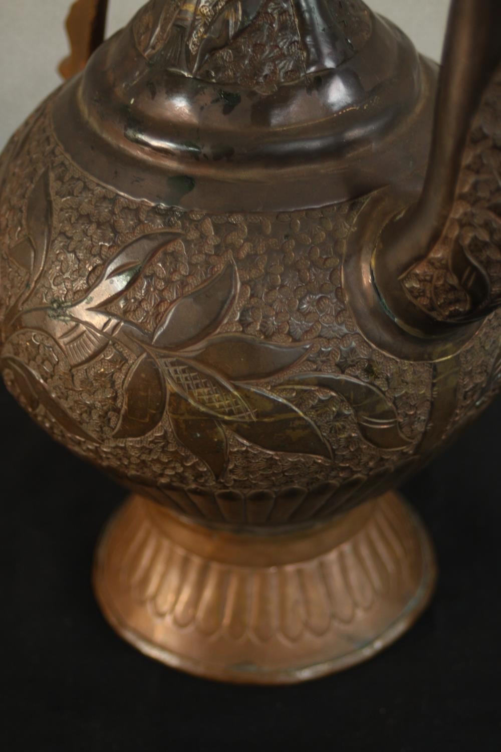 A Turkish engraved copper ewer decorated with a foliate design. H.37 W.24 D.13cm. - Image 10 of 12