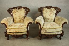 A pair of late 20th century carved and lacquered armchairs, upholstered in cream coloured foliate