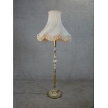 A circa 1970's onyx and brass standard lamp, with a circular base on paw feet and shade. H.159 W.