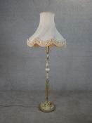 A circa 1970's onyx and brass standard lamp, with a circular base on paw feet and shade. H.159 W.