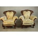 A pair of late 20th century carved and lacquered armchairs, upholstered in cream coloured foliate
