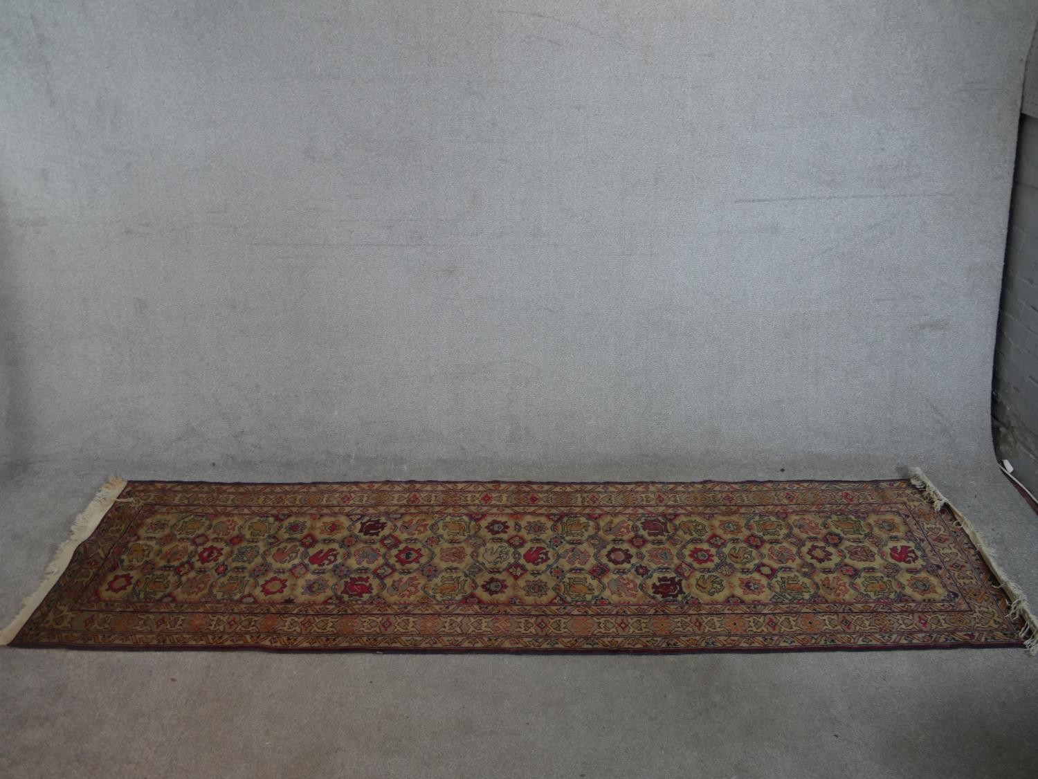 A biscuit ground hand made Erevan Russian runner. W.303 D.82cm