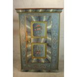 An early 19th century central European painted pine cupboard, painted in hues of blue, 1803, with