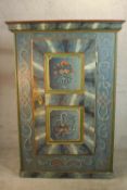 An early 19th century central European painted pine cupboard, painted in hues of blue, 1803, with