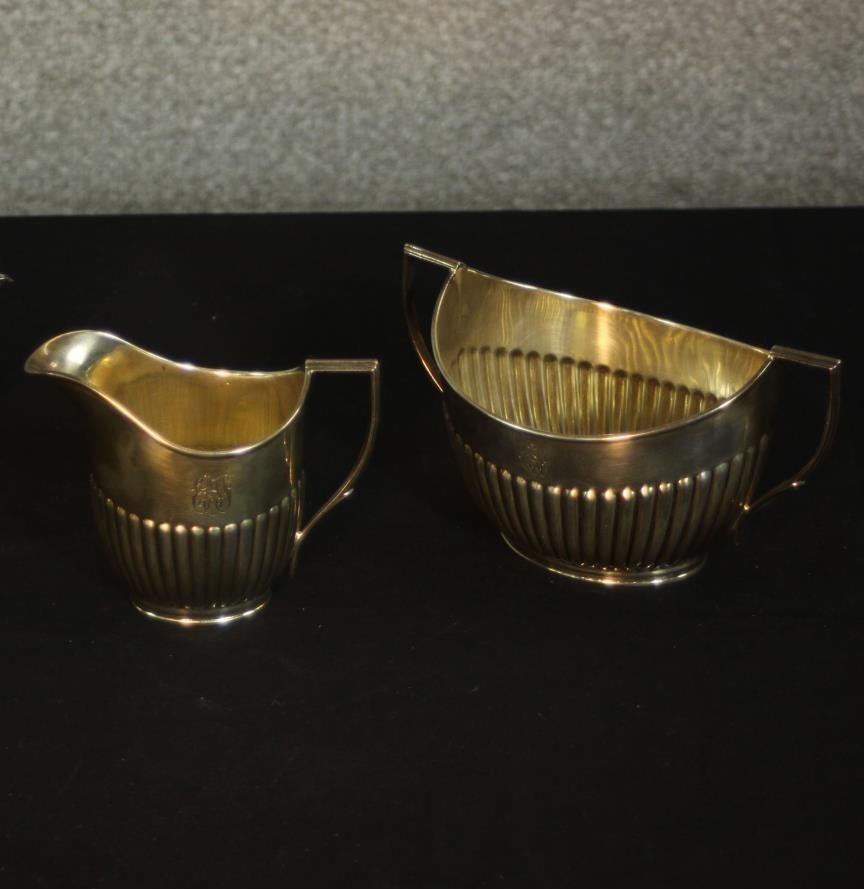 An Edward VII gadrooned silver sugar bowl and milk jug. Hallmarked: William Hutton & Sons Ltd,