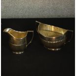 An Edward VII gadrooned silver sugar bowl and milk jug. Hallmarked: William Hutton & Sons Ltd,