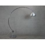 A chrome Arc style lamp, with a brushed aluminium shade, a curved tubular body and a circular