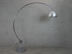 A chrome Arc style lamp, with a brushed aluminium shade, a curved tubular body and a circular