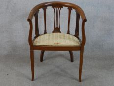 Edwardian mahogany framed open arm bow back chair raised on square tapering supports terminating