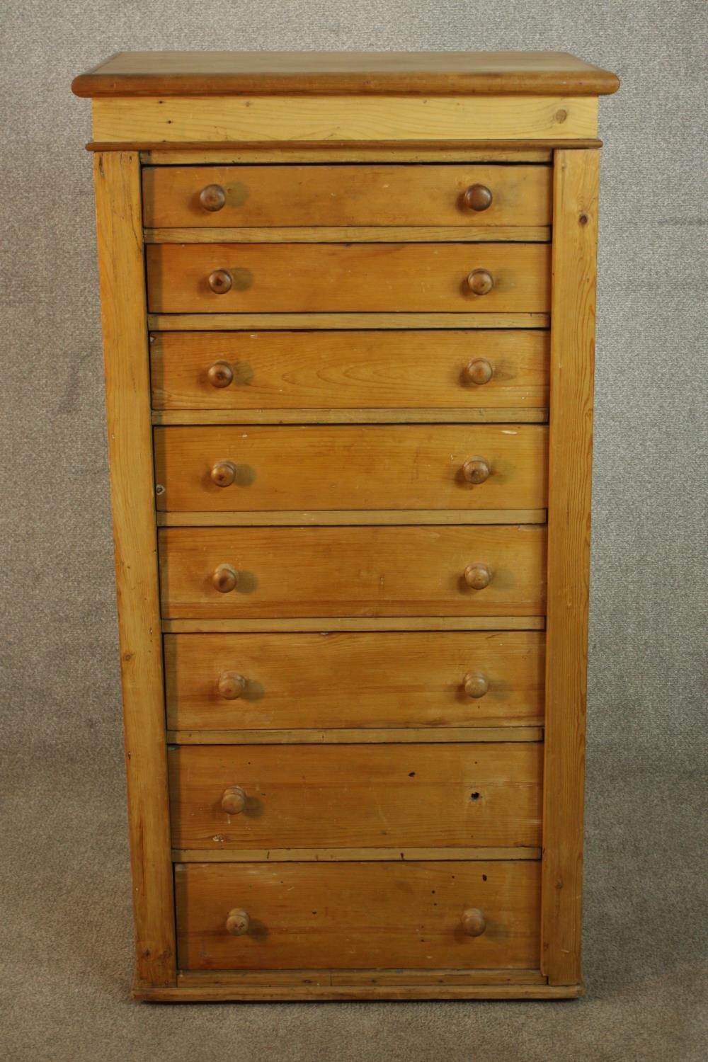 A C19th pine Wellington chest with locking stile, the eight graduated drawers with knob handles. H.