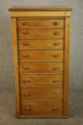 A C19th pine Wellington chest with locking stile, the eight graduated drawers with knob handles. H.