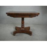 A William IV mahogany card table, with a crossbanded top and green baize interior, on a turned and