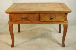 An early 20th century far Eastern hardwood, possibly Narra wood (amboyna) desk, with two carved