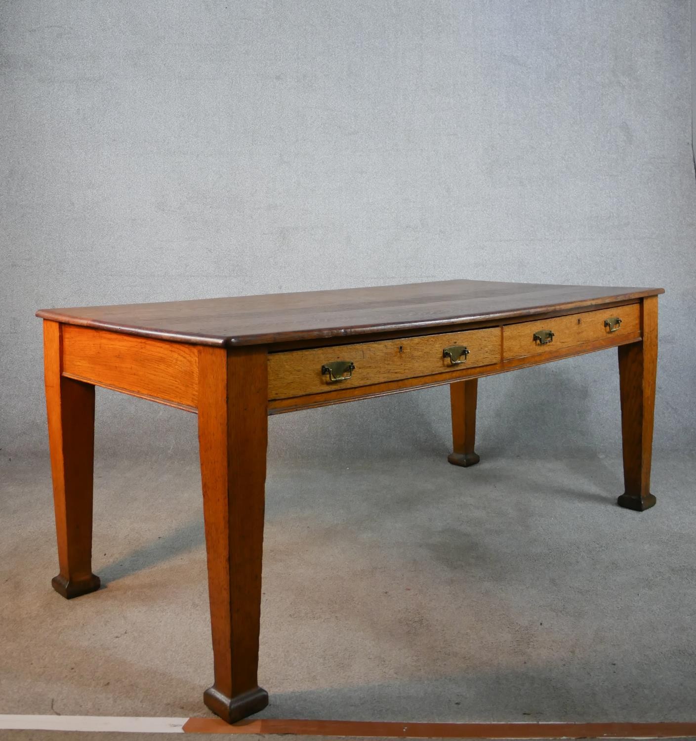 An early 20th century oak two drawer writing table raised on tapering supports terminating in square - Image 6 of 6