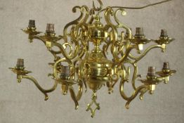 A twelve branch brass electroiier of Gothic style, H.54 Dia.72cm.