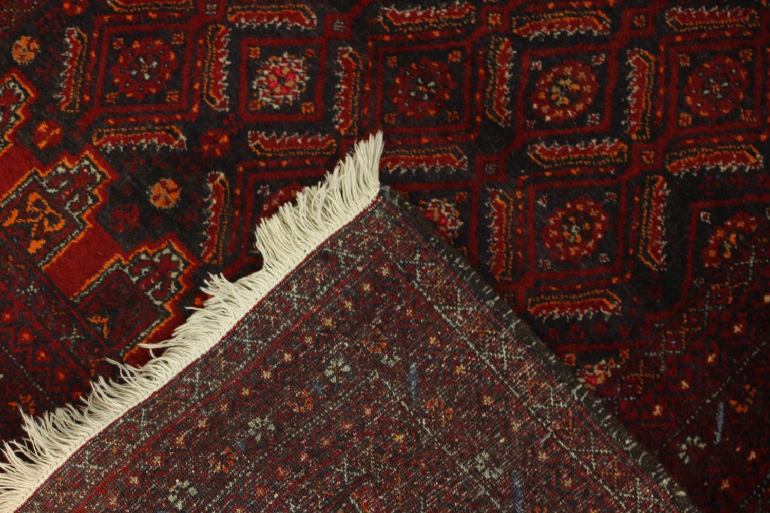 A red ground Baluch rug with all over geometric pattern. L.190 W.88cm. - Image 5 of 6