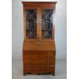 A Victorian walnut bureau bookcase, the two astragal glazed doors enclosing adjustable shelves, over