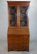 A Victorian walnut bureau bookcase, the two astragal glazed doors enclosing adjustable shelves, over