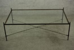 Contemporary glass and iron coffee table, raised on 'X' framed stretcher and turned supports H.36