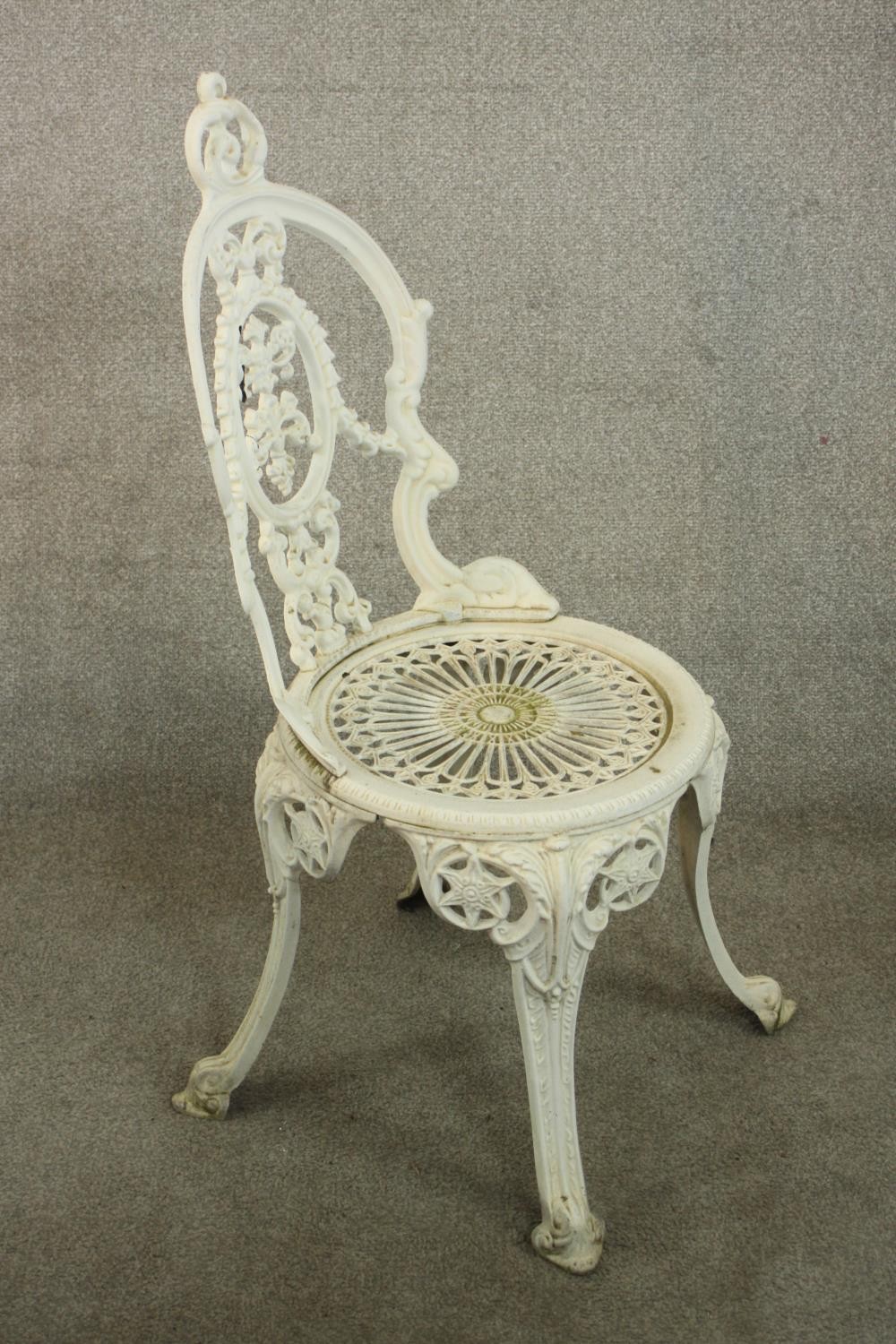 A Victorian style white painted wrought iron garden set comprising of matching four chairs and a - Image 6 of 10