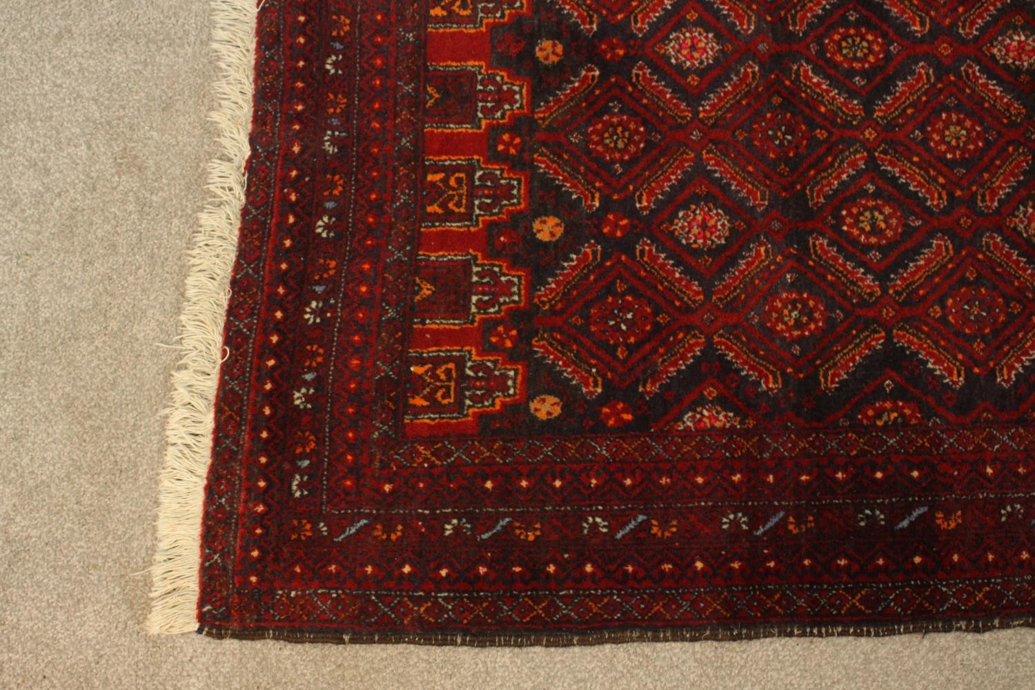 A red ground Baluch rug with all over geometric pattern. L.190 W.88cm. - Image 4 of 6