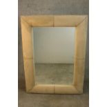 A contemporary rectangular mirror in a cream faux suede cushion frame. H.122 W.190