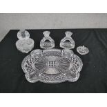 An Art Deco cut glass dressing table set, including a pair of candlesticks, ring holder, lidded