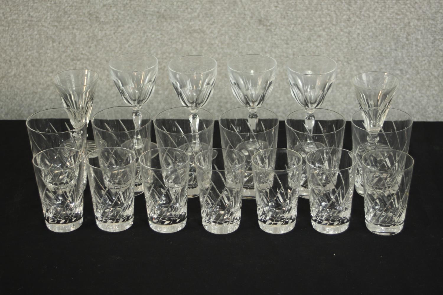 A collection of nineteen hand cut crystal glasses, including six whisky tumblers and seven