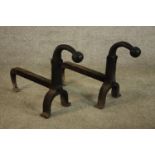 A pair of wrought iron fire dogs. H.40 W.23 D.53cm. (each)