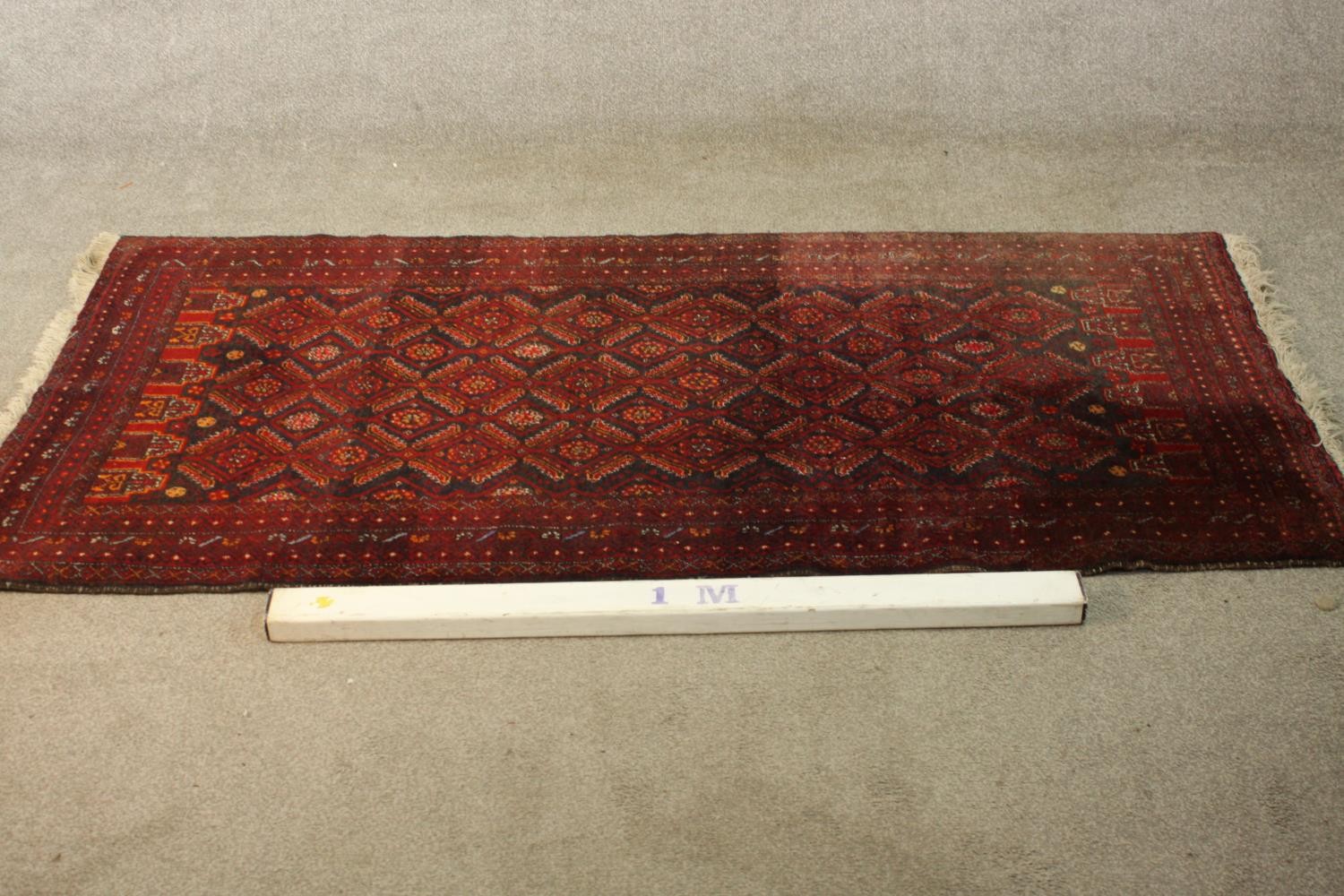 A red ground Baluch rug with all over geometric pattern. L.190 W.88cm. - Image 2 of 6