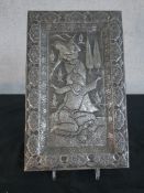 A repousse middle eastern silvered plaque with wedding scene of female handing seated male a glass