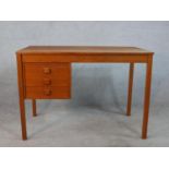 A circa 1970s Danish Domino Mobler teak desk, the rectangular top over three drawers, on square