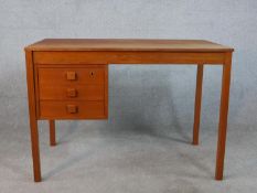 A circa 1970s Danish Domino Mobler teak desk, the rectangular top over three drawers, on square