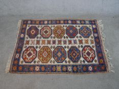 A cream ground hand made Turkish Kars rug. W.140 D.104cm