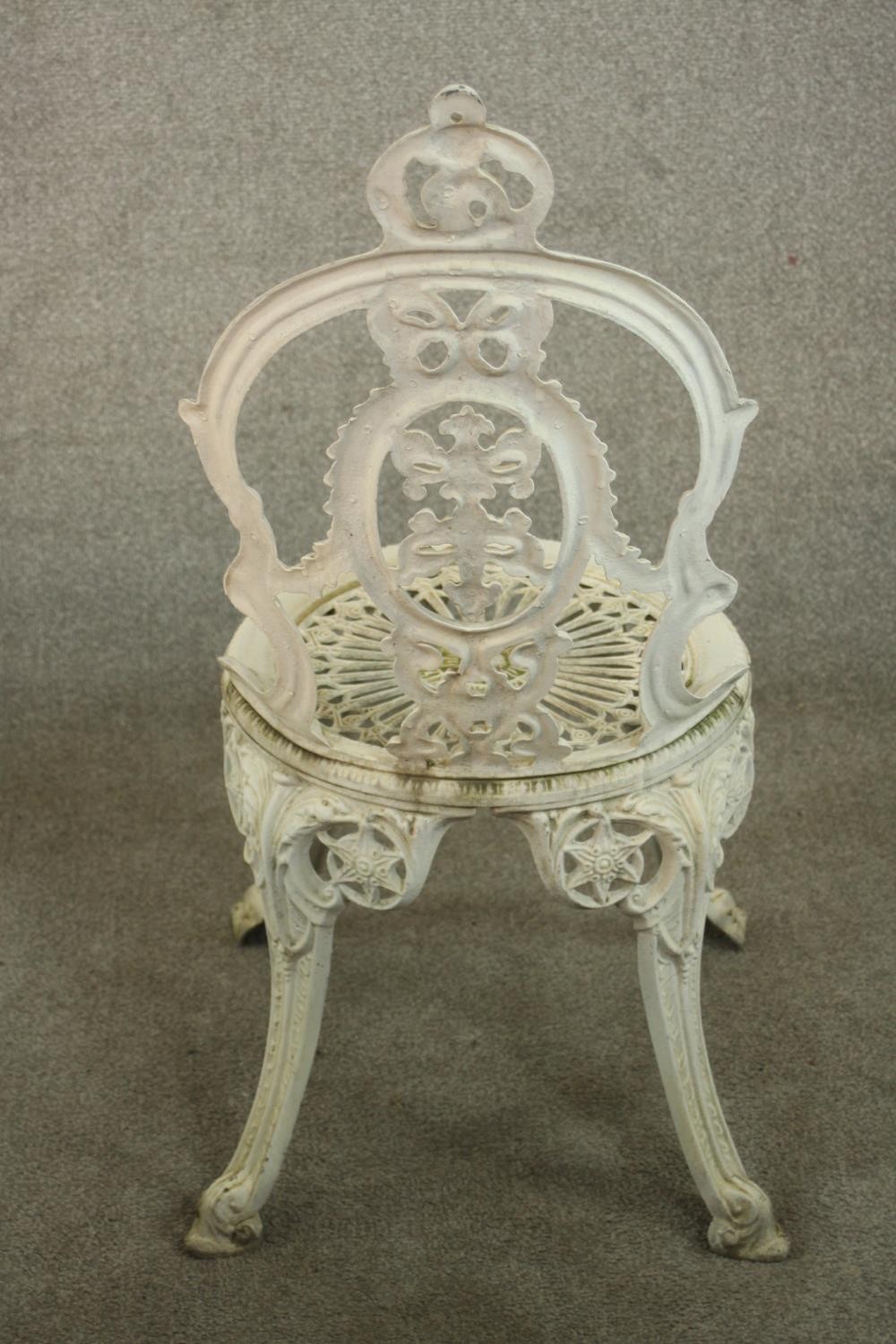 A Victorian style white painted wrought iron garden set comprising of matching four chairs and a - Image 8 of 10