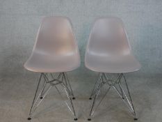 A pair of grey plastic Charles Eames DSR side chairs, designed by Charles and Ray Eames in 1950 with