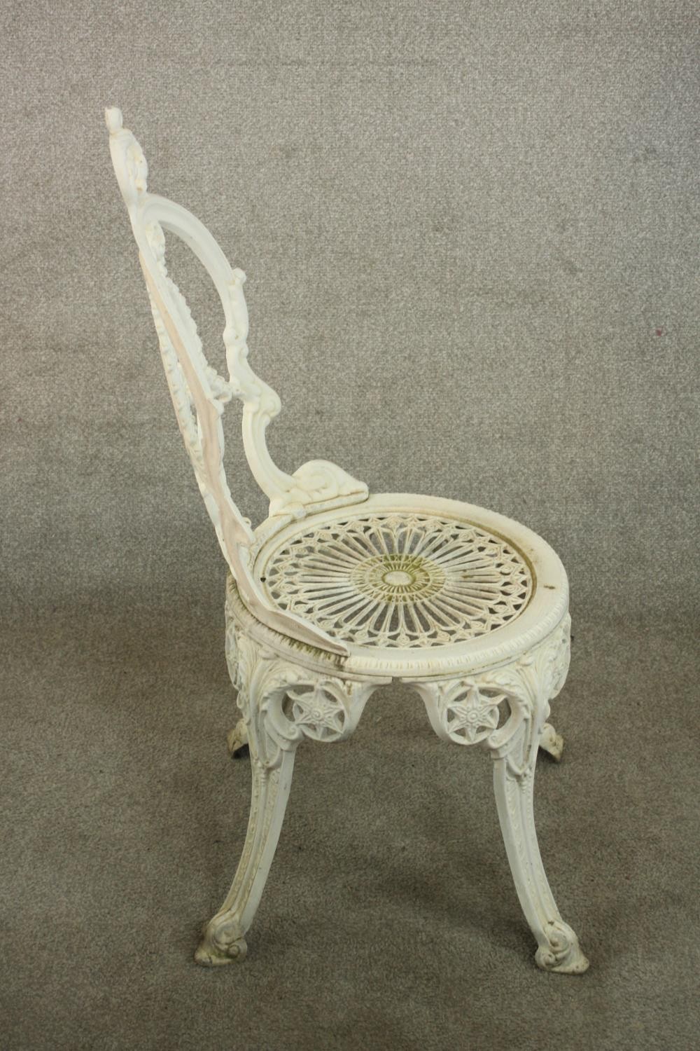 A Victorian style white painted wrought iron garden set comprising of matching four chairs and a - Image 7 of 10