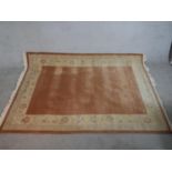 A camel ground hand made Tibetan carpet. W.265 D.170cm