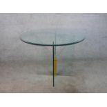 A contemporary circular occasional table, the plate glass top with a bevelled edge on a cross form