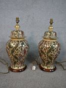 A pair of 20th century Japanese pottery table lamps in the form of jars, decorated with feathers