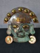 A patinated copper and brass Inka mask. H.30 W.24cm