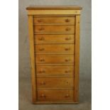 A C19th pine Wellington chest with locking stile, the eight graduated drawers with knob handles. H.