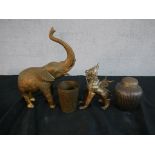 Four assorted brass Asian ornaments to include an elephant, seated dragon, jar and cover and a