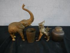 Four assorted brass Asian ornaments to include an elephant, seated dragon, jar and cover and a